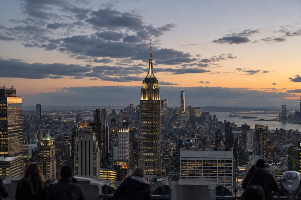 The Empire State Building rising above the Midtown Manhattan skyline at dusk