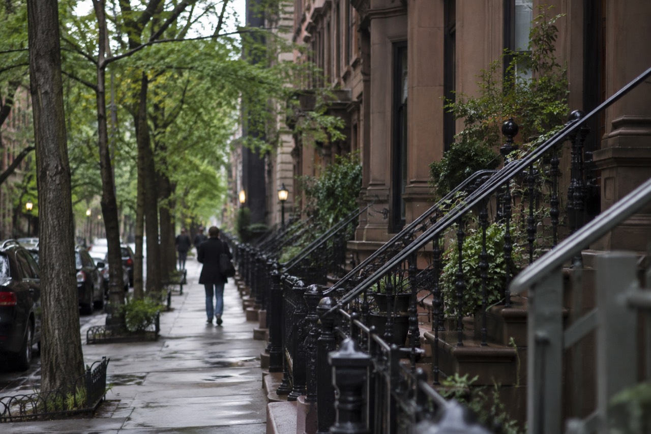 A brownstone stoop on a quiet tree-lined street in the West Village