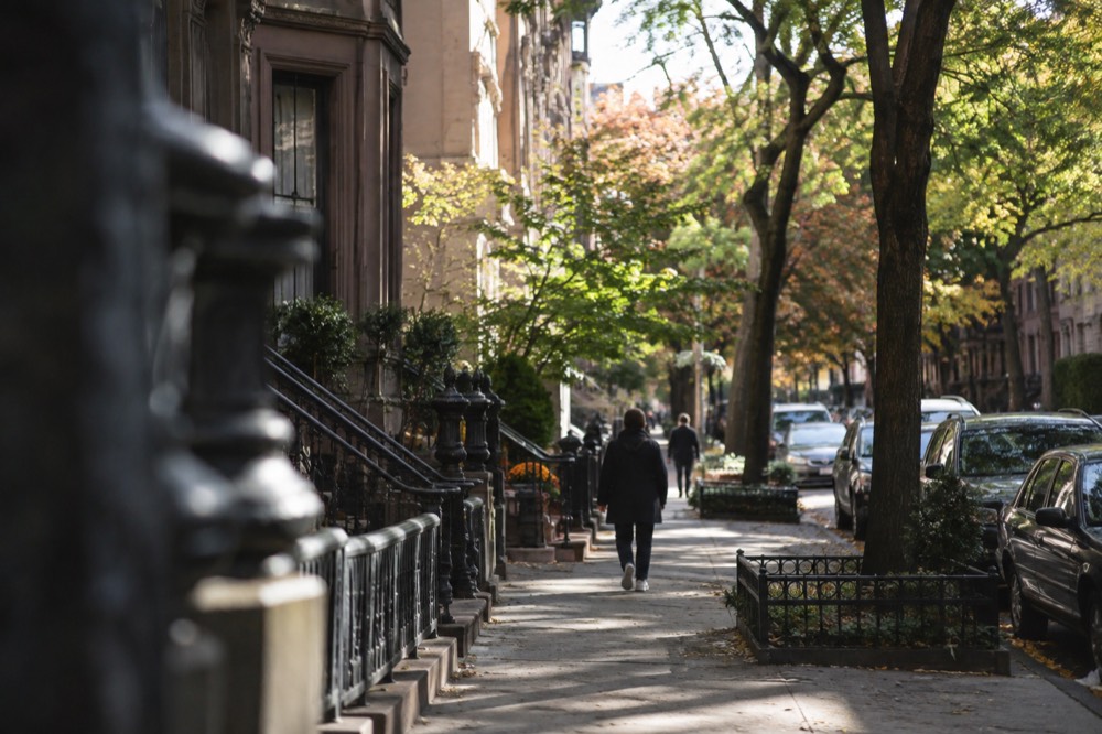 A quiet residential street with brownstones on the Upper West Side in the morning