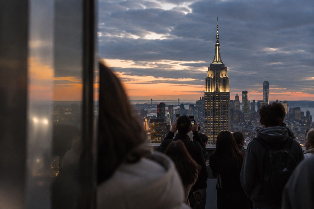 Midtown Manhattan skyline at dusk with the Empire State Building lit in the distance