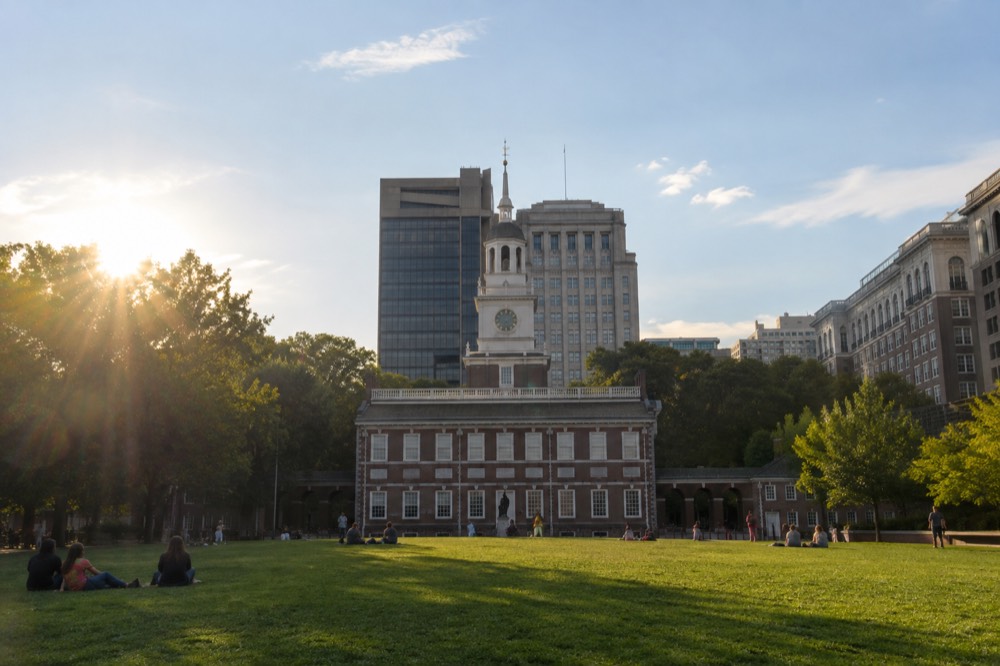Independence Hall in Philadelphia seen from a green lawn under a clear sky