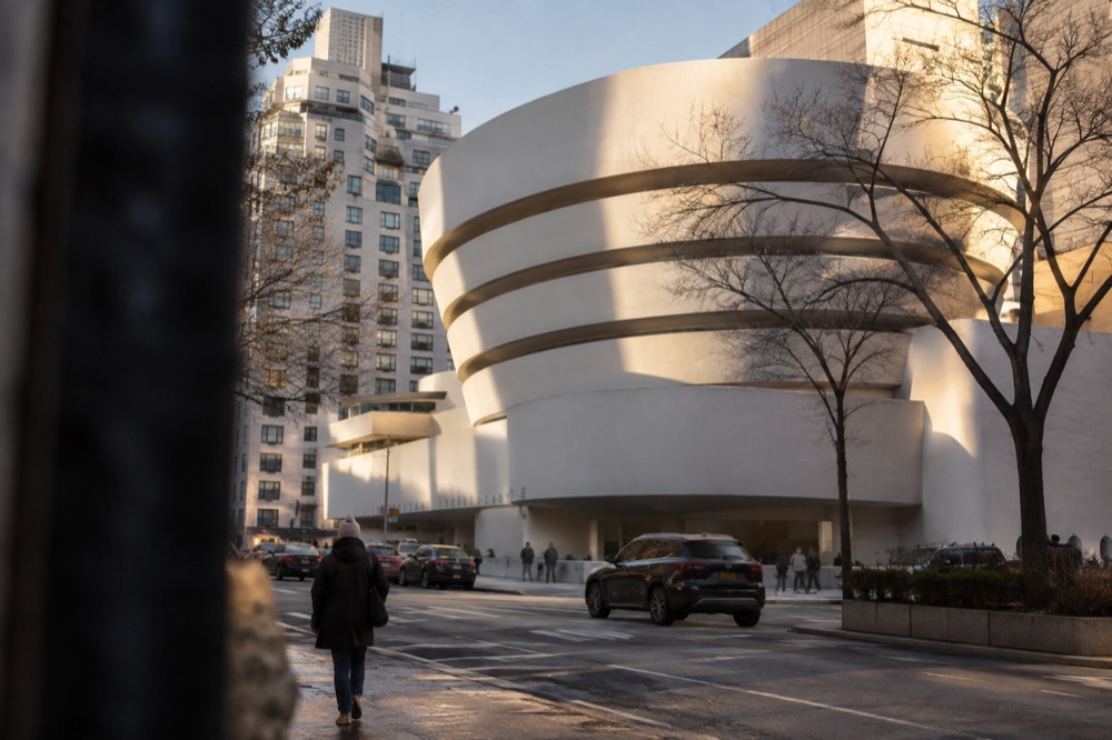 The round spiral exterior of the Guggenheim Museum rising above Fifth Avenue on a bright day