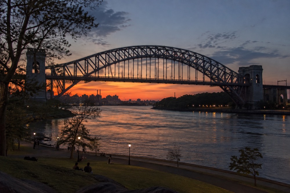 Sunset over the East River from Astoria Park, with the Hell Gate Bridge spanning the water in the foreground