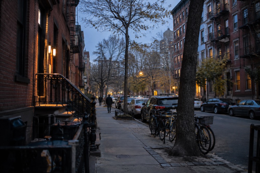 A quiet East Village side street in the early morning with parked bicycles and brick facades