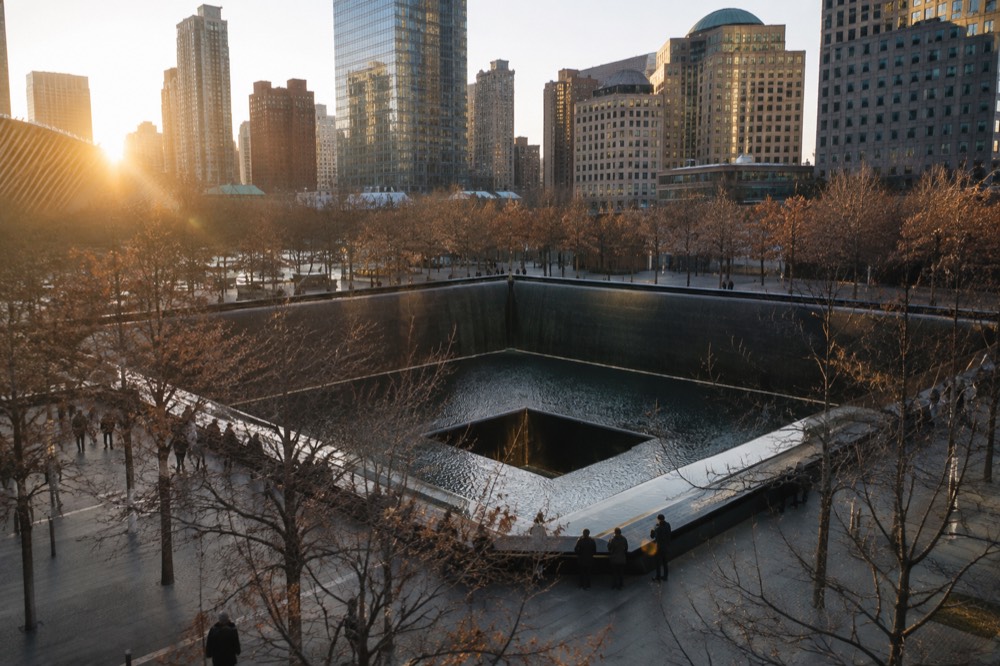 The reflecting pools of the 9/11 Memorial set into the World Trade Center plaza