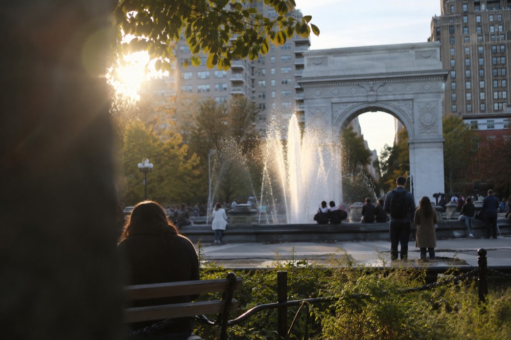 Washington Square Park with the marble arch and people gathered around the fountain