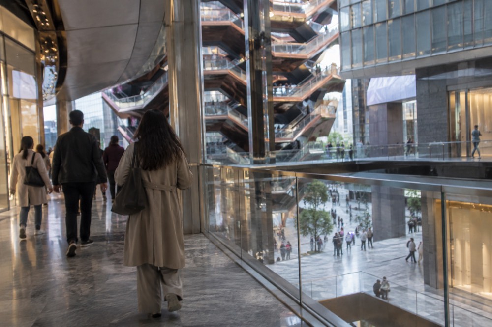 Shoppers and visitors walking through a bright multi-level retail atrium