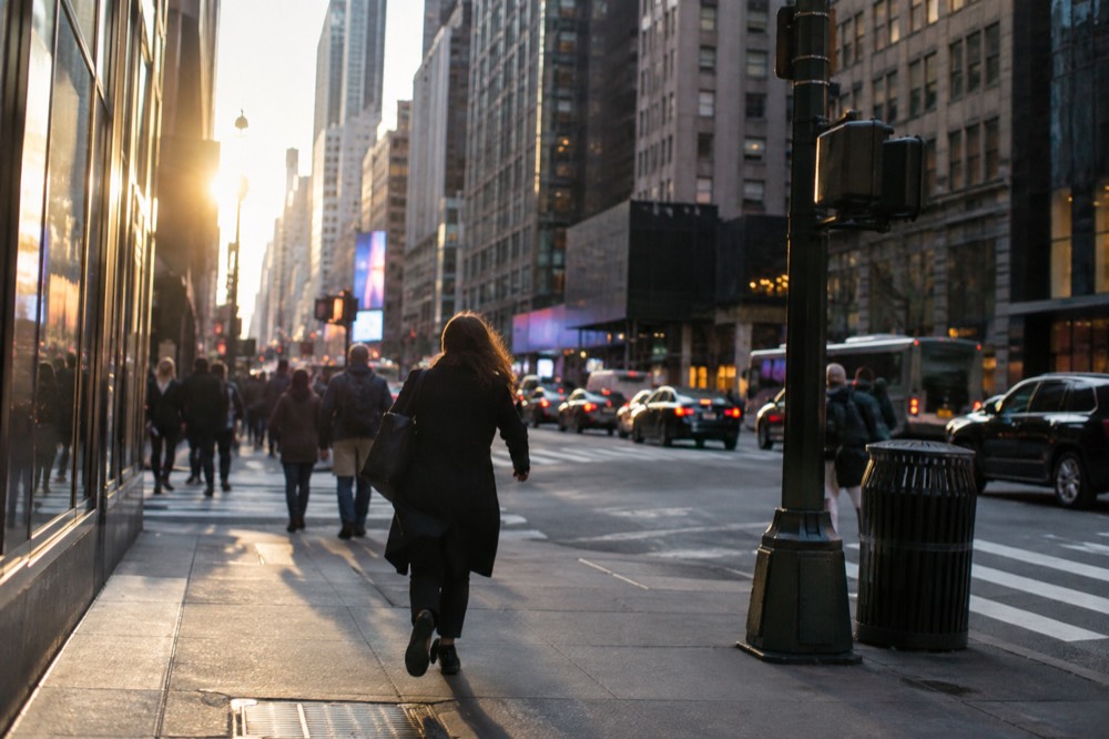 Midtown Manhattan skyscrapers rising above busy crosswalks at street level