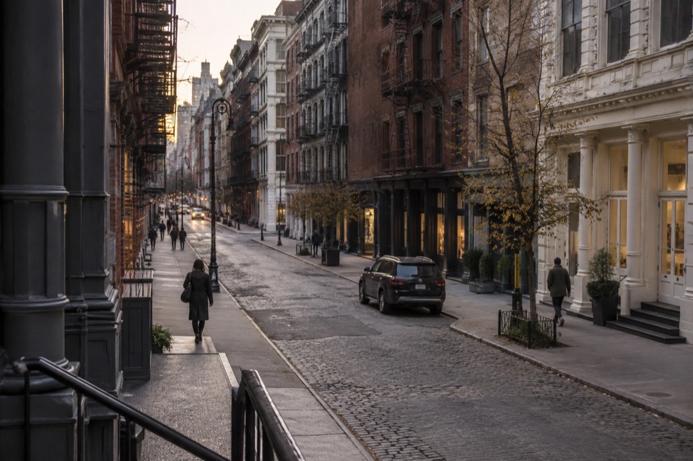 Evening light on a quiet SoHo street with cast-iron lofts above closed shops
