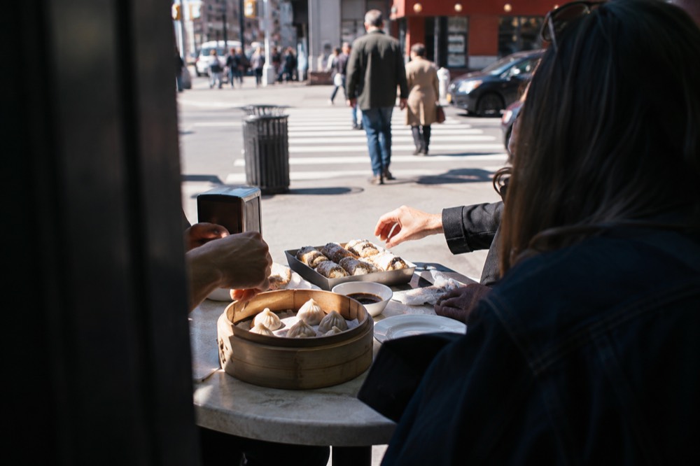 A table of dumplings and cannoli shared during a food tour