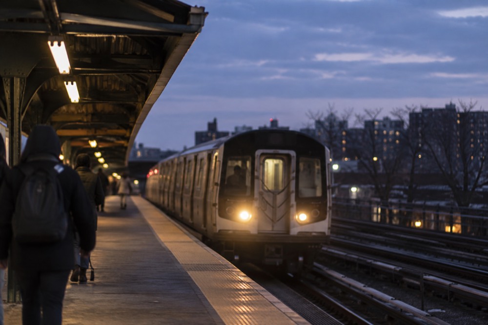 A subway platform in the Bronx with a train arriving