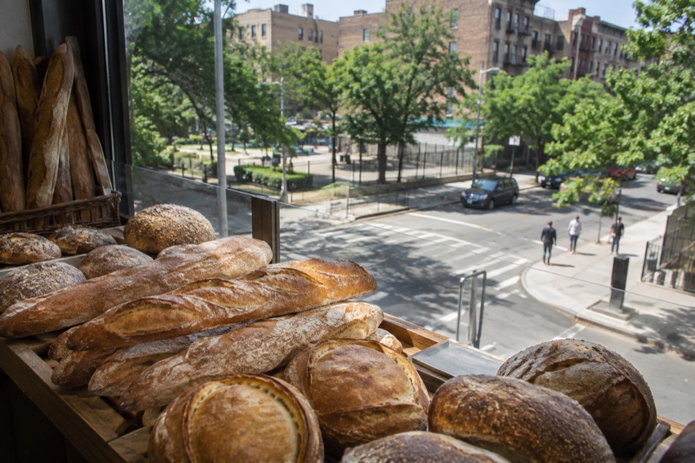 Fresh bread loaves stacked on a bakery counter