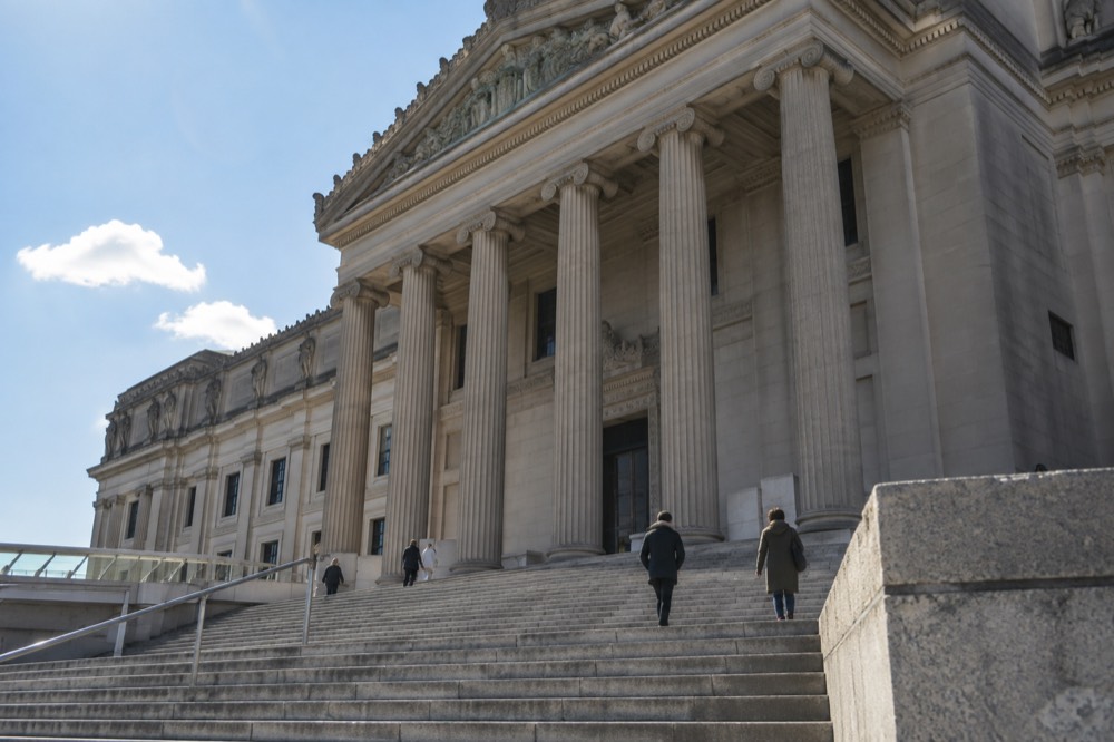The columned facade of the Brooklyn Museum seen from the front steps on a clear afternoon