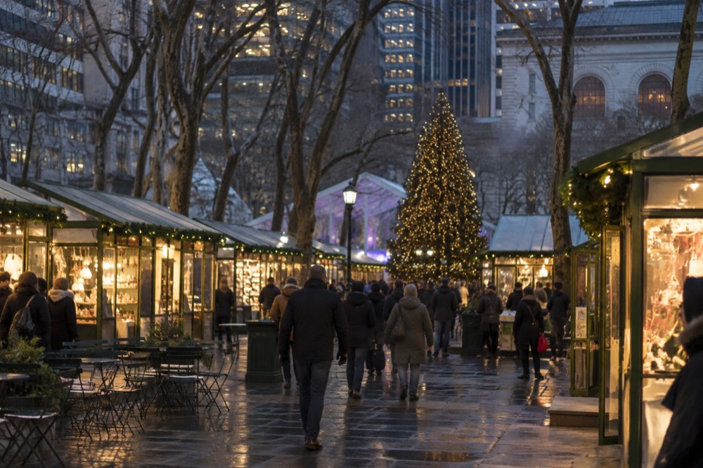 Evening view of illuminated holiday market stalls lining the paths of Bryant Park