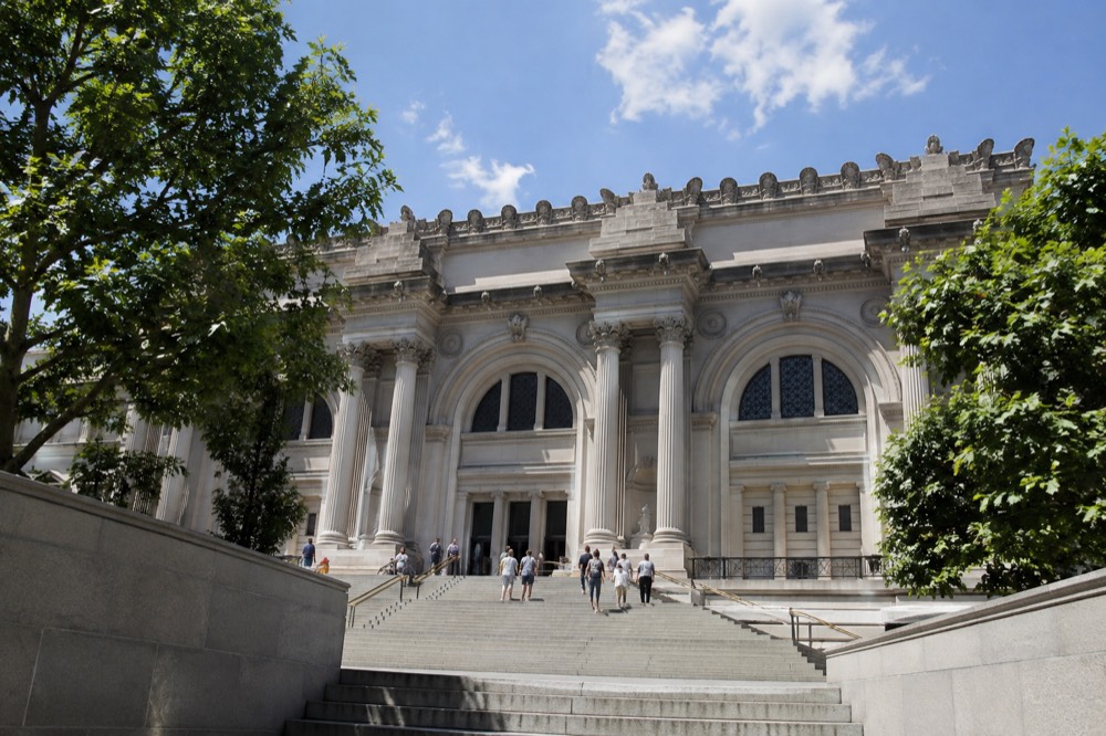 The Metropolitan Museum of Art entrance with park trees on either side