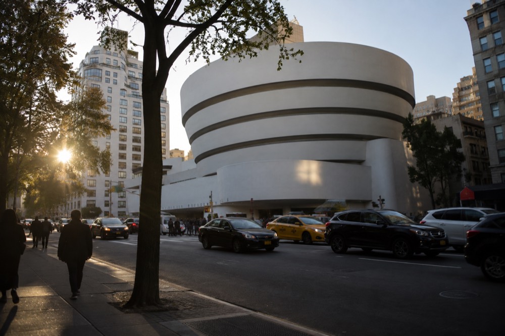 The curved white spiral facade of the Guggenheim Museum seen from Fifth Avenue