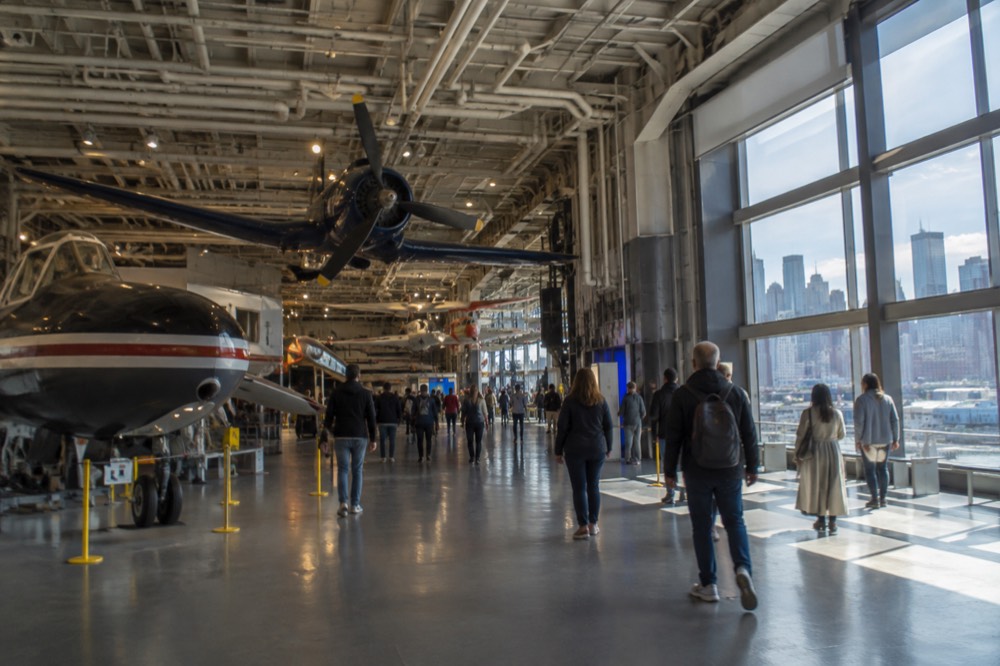 The hangar deck interior with aircraft suspended from the ceiling and exhibit lighting below