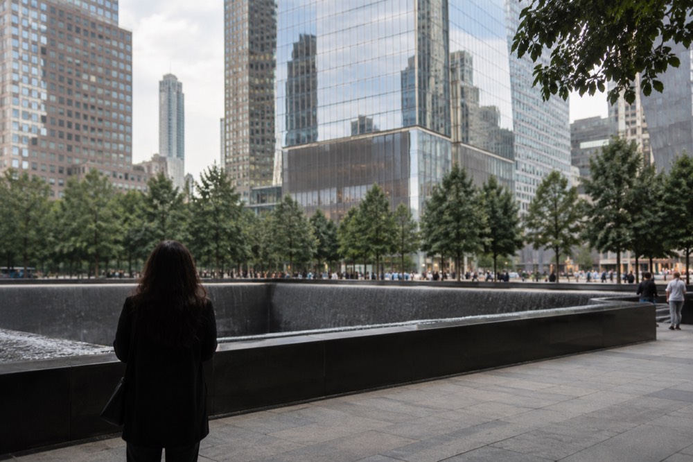 The entrance plaza of One World Trade Center with the reflecting pools of the 9/11 Memorial nearby