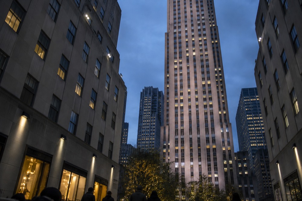 Looking up at the limestone towers of Rockefeller Center from the plaza below