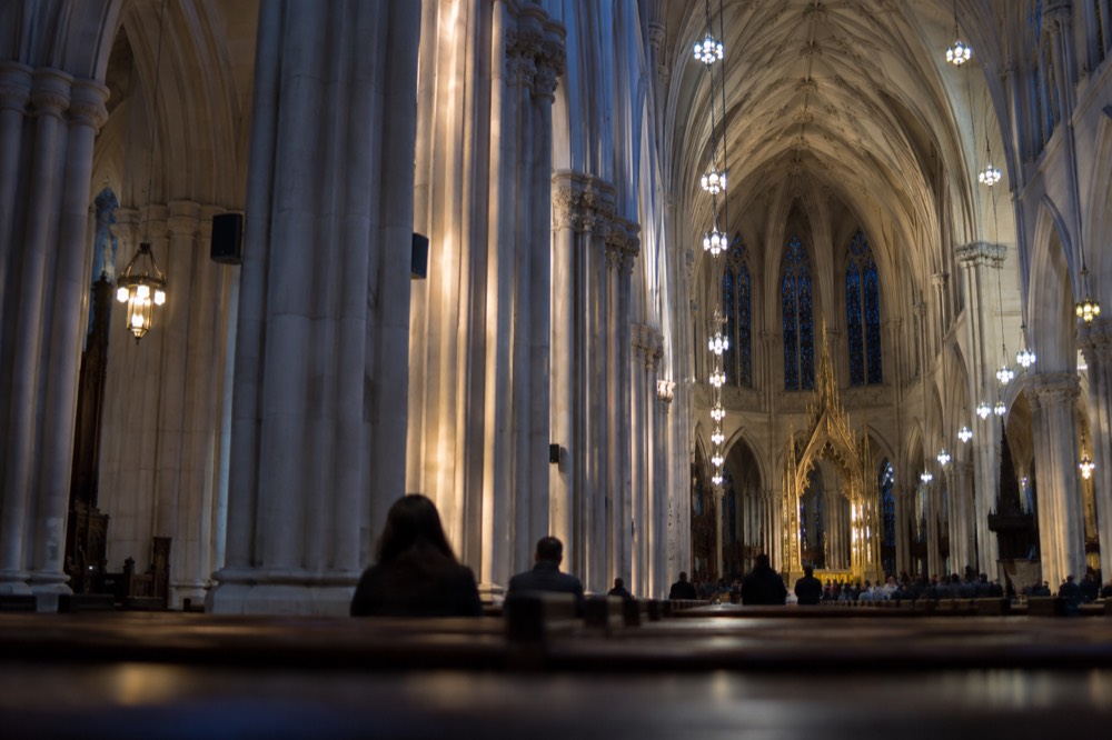 Sunlight falling on the rows of stone columns inside the nave of St Patrick's Cathedral