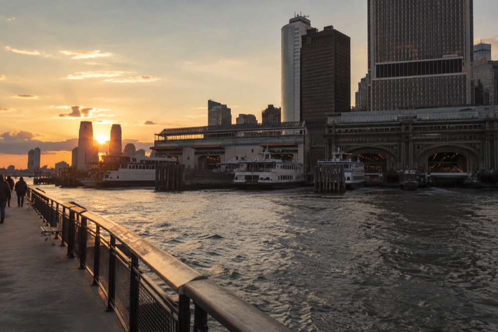 The waterfront terminal building at the foot of Manhattan with ferry boats moored outside