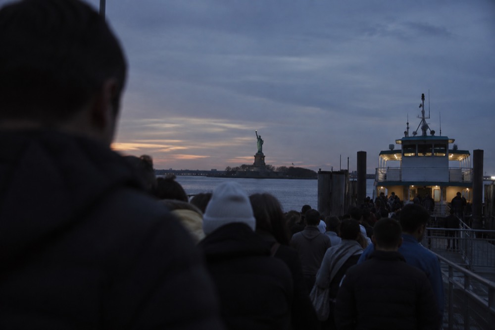 Crowds gathered at the Liberty Island ferry dock waiting to board