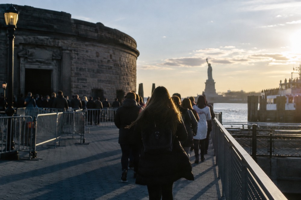 Castle Clinton's stone circular fort inside Battery Park with ferry queues nearby