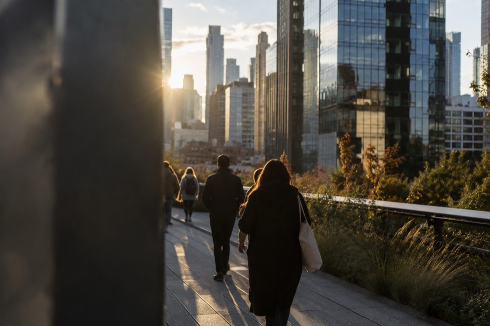 The High Line walkway passing between glass residential towers near Hudson Yards