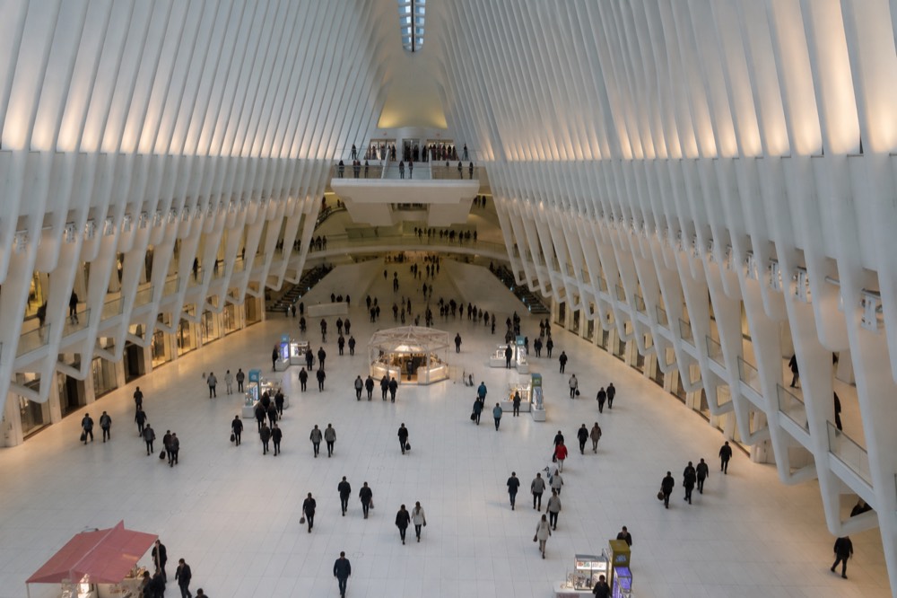 The white marble concourse of The Oculus with shoppers walking beneath the ribs