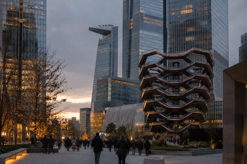 The Hudson Yards plaza at dusk with Vessel, surrounding towers and the Edge observation deck in view