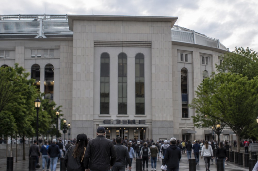 The main entrance of Yankee Stadium with fans gathering near the gates before a game