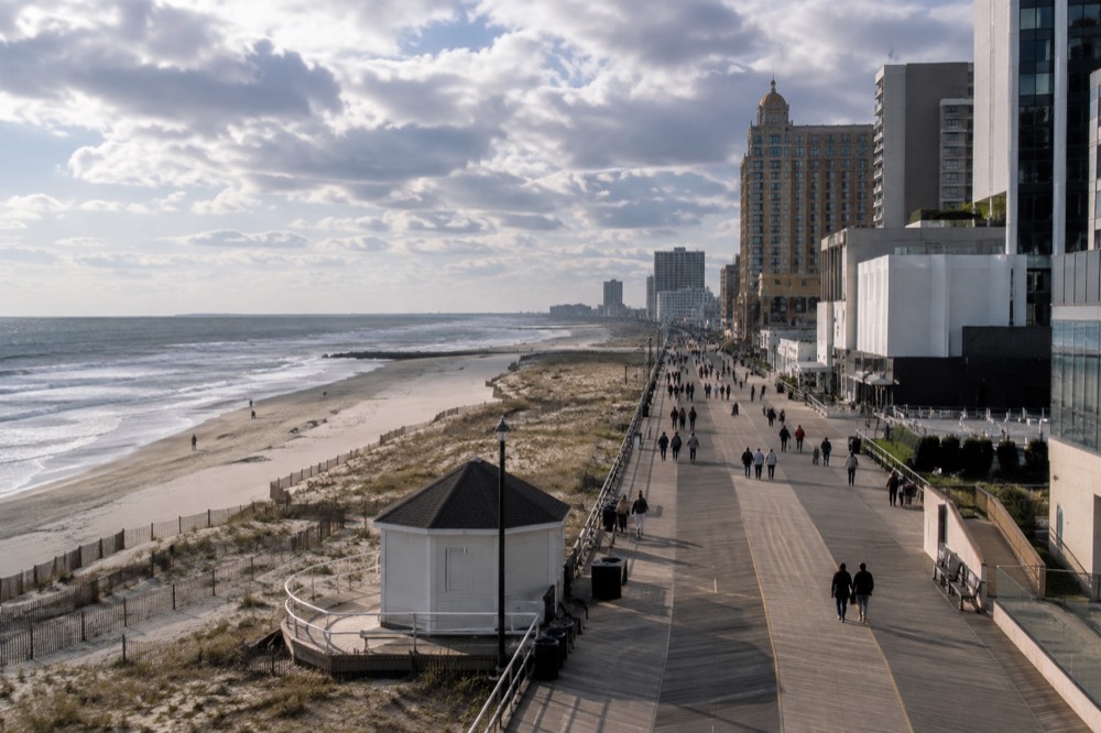 The Atlantic City Boardwalk stretching along the beach with hotels on one side and the ocean on the other