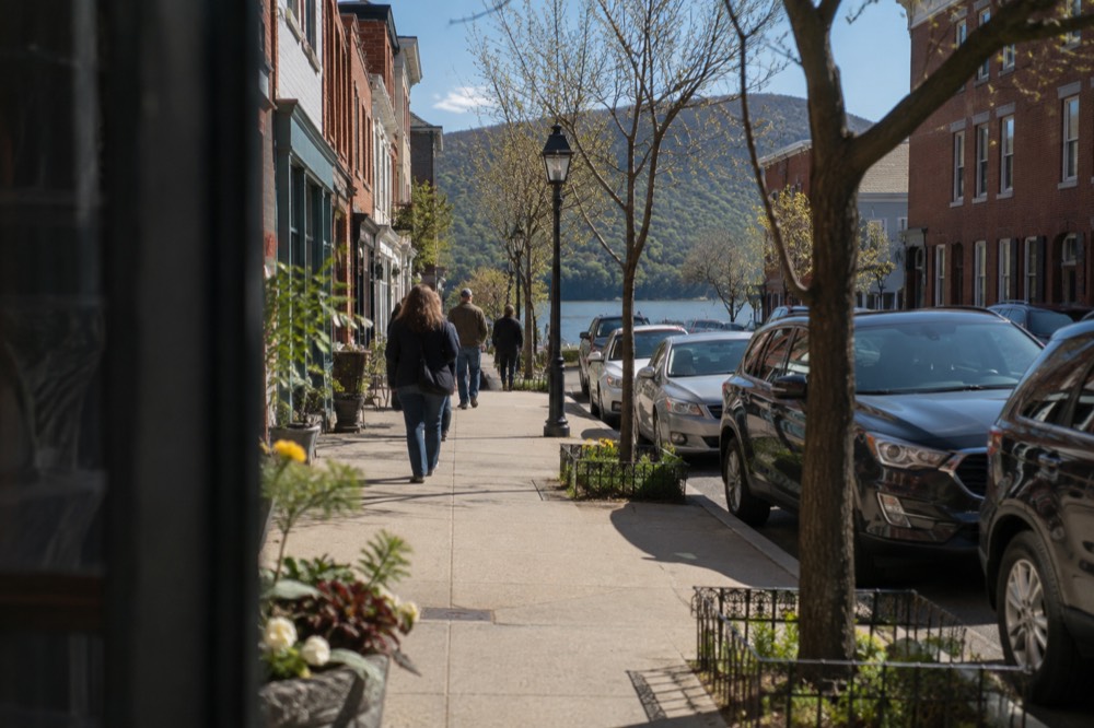 A small Hudson River village main street with hills rising behind the rooftops