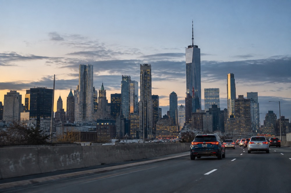 The skyline of Manhattan seen from a highway approach with morning light on the towers