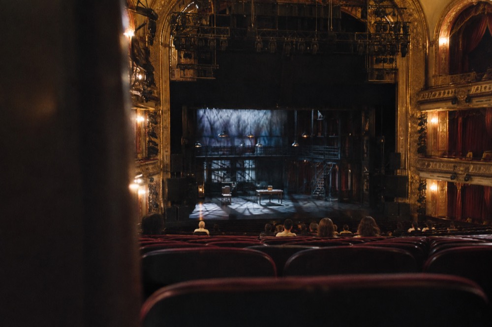An empty Broadway theater auditorium seen from the back rows before a performance