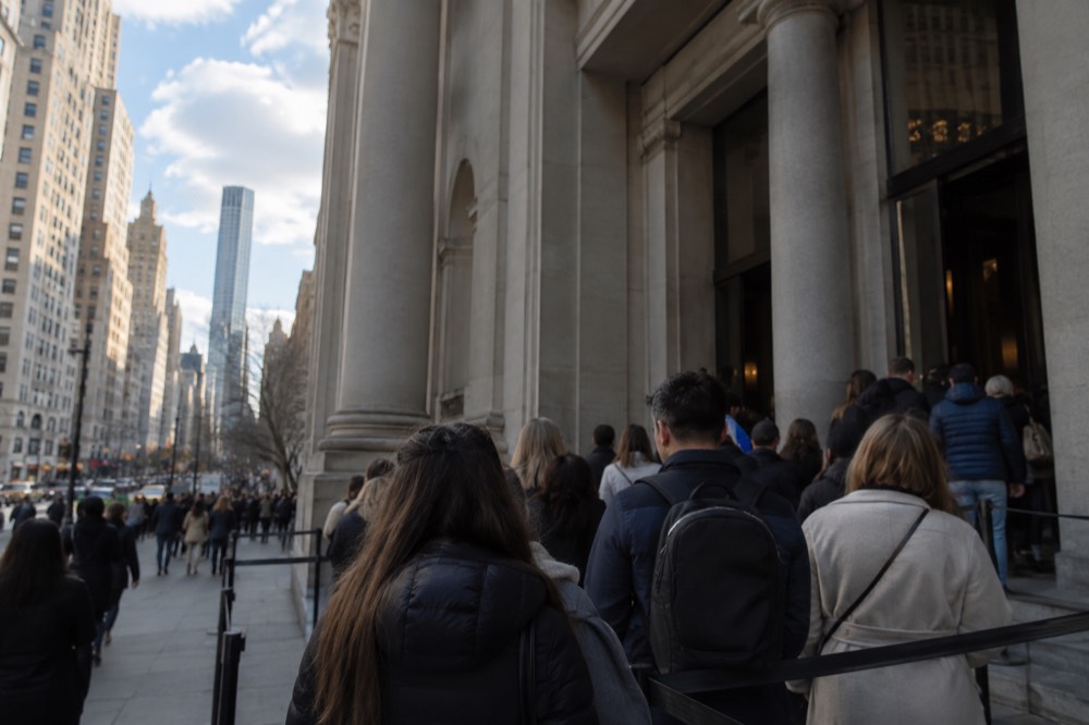 Tourists queueing at the entrance of a Midtown Manhattan museum on a busy afternoon