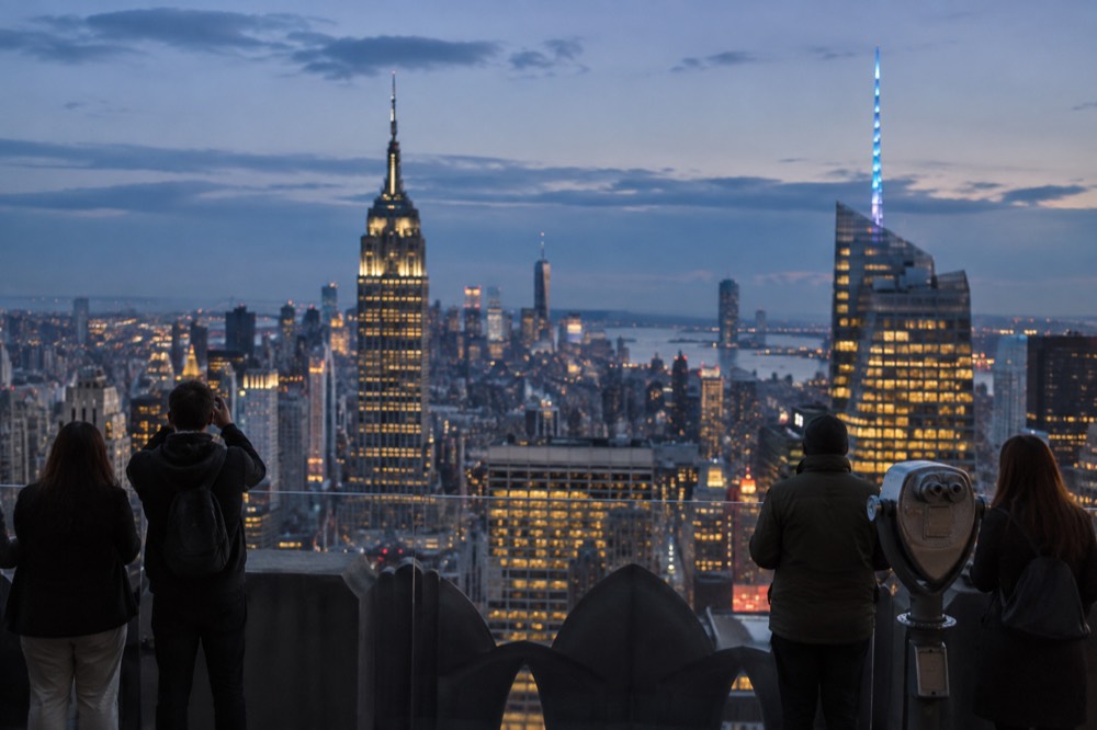 Visitors on a New York observation deck looking out over Midtown Manhattan skyscrapers