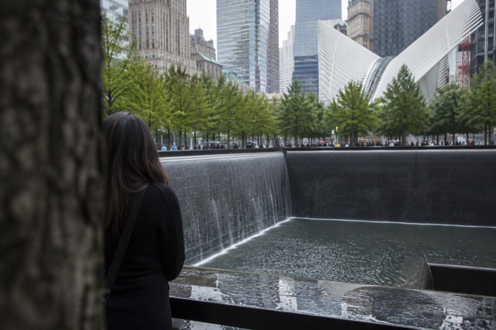 The reflecting pools of the 9/11 Memorial seen from street level