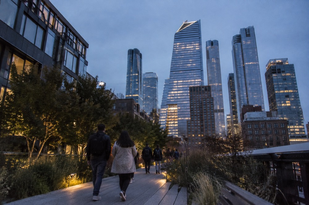 Walkers on the High Line with Hudson Yards towers behind them
