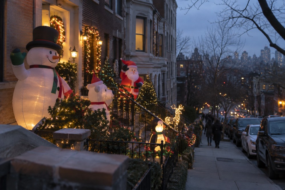 A decorated Brooklyn home covered in oversized inflatable Christmas figures and strings of lights