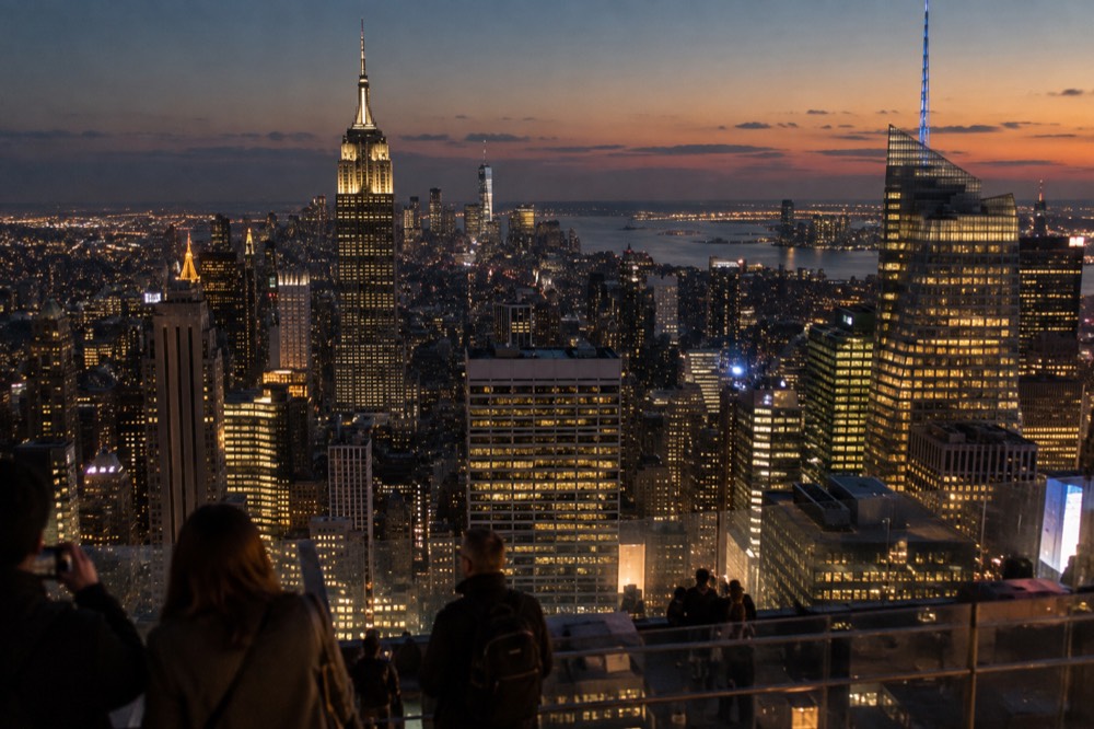 A city view at night from a high observation deck with Midtown towers lit up