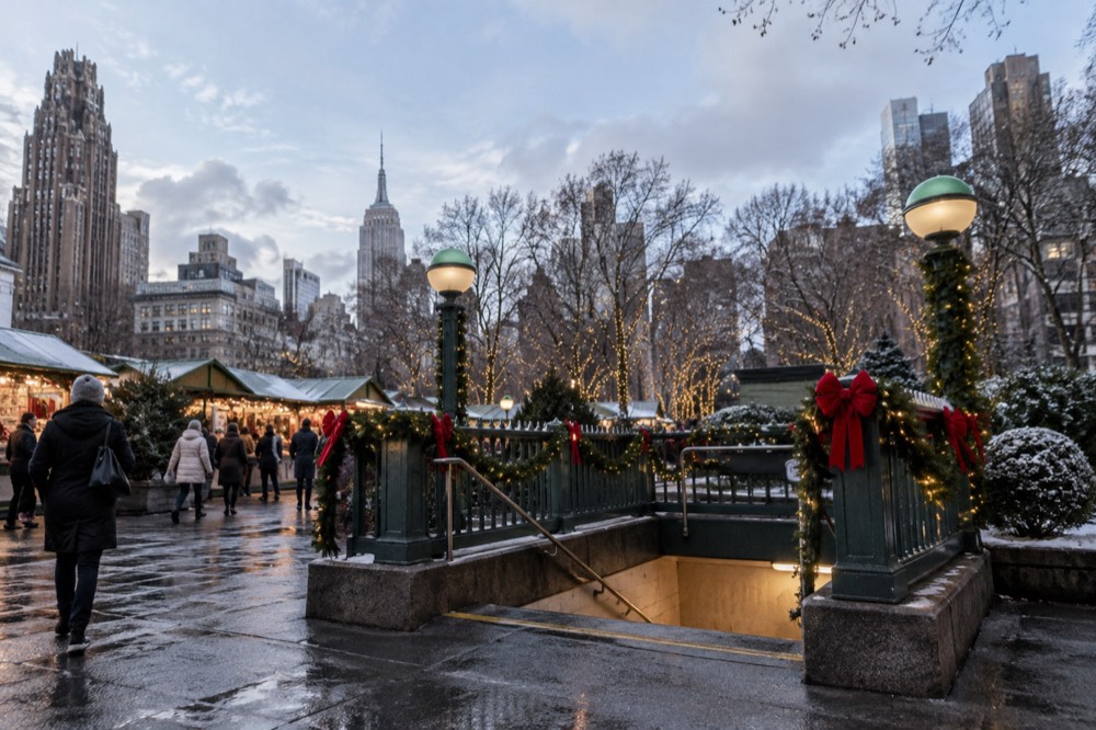 A subway entrance decorated for the holidays near a Manhattan Christmas market