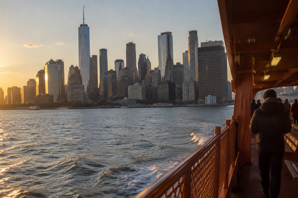 The Staten Island Ferry crossing New York Harbor with Lower Manhattan towers behind it