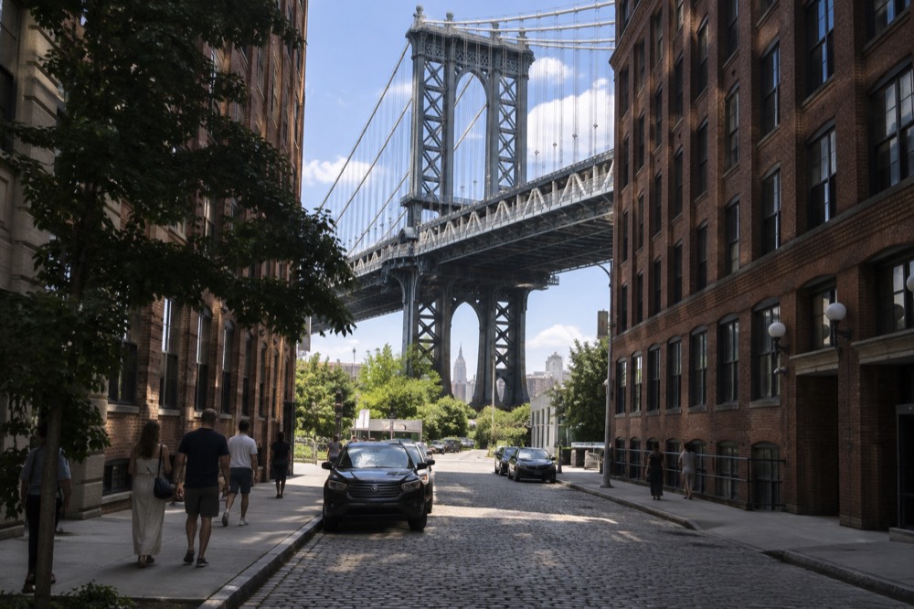 Cobblestone street in DUMBO framed by the Manhattan Bridge above