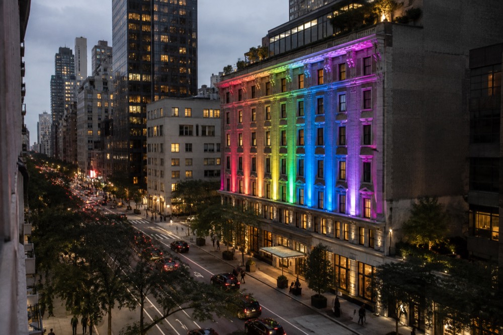 A boutique hotel facade with rainbow lighting in the evening in Manhattan