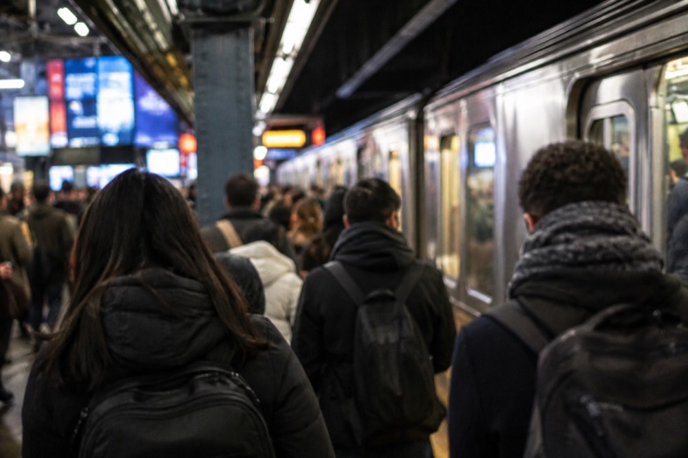 A crowded subway platform at Times Square station during rush hour