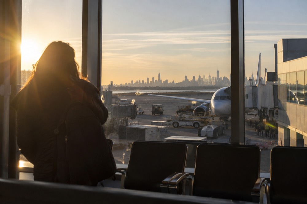 Terminal buildings at LaGuardia Airport with the Manhattan skyline in the far distance