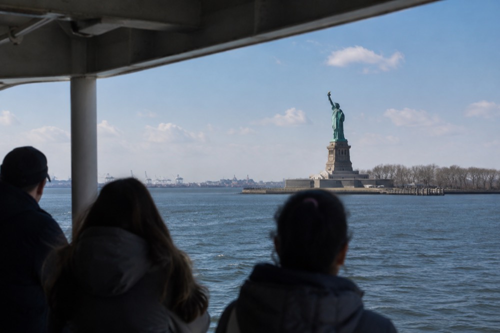 The Statue of Liberty seen from the deck of a ferry crossing New York Harbor